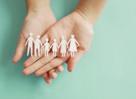 Hands holding multi generation family paper